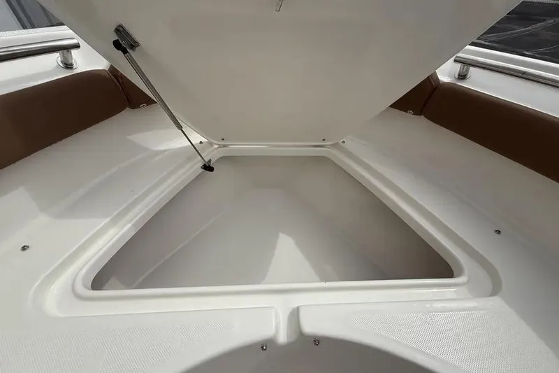 Slide: The Image of 2026 Pioneer 202 Islander boat storage compartment with open hatch, showcasing spacious interior. - 12