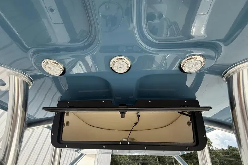 Slide: The Image of 2026 Pioneer 202 Islander boat interior with blue ceiling and built-in lighting. - 13