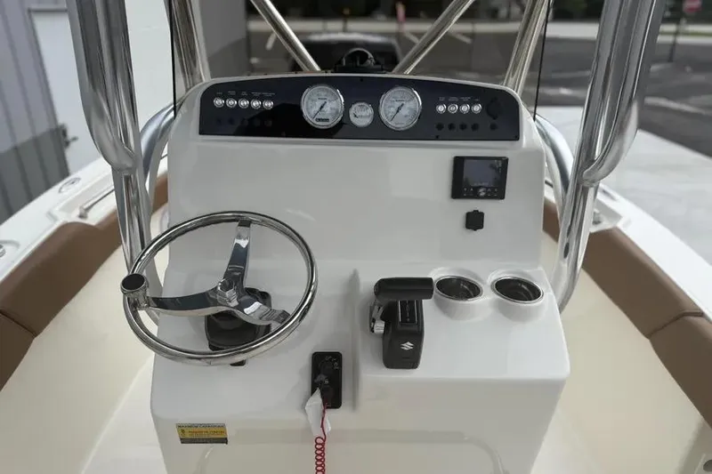 Slide: The Image of 2026 Pioneer 202 Islander boat dashboard with steering wheel and controls. - 7