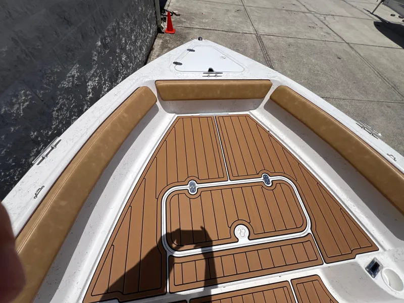 Slide: The Image of ALK2 Powerboats 18 CRS 2024 with wood-look deck and seating area. - 16