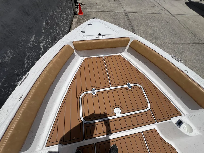 Slide: The Image of ALK2 Powerboats 18 CRS 2024 with wood-look deck and seating area. - 17