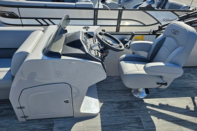 Slide: The Image of 2026 Bentley Pontoons Legacy 243 Swingback helm with luxurious captain's chair and sleek dashboard. - 14