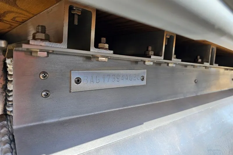 Slide: The Image of Close-up of 2026 Bentley Pontoons Legacy 243 Swingback metal structure with serial number. - 17