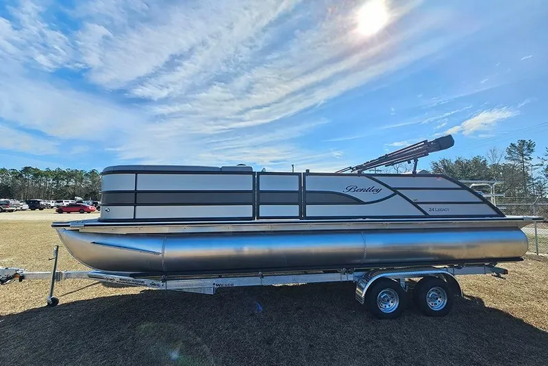 Slide: The Image of 2026 Bentley Pontoons Legacy 243 Swingback on trailer under a clear blue sky. - 4