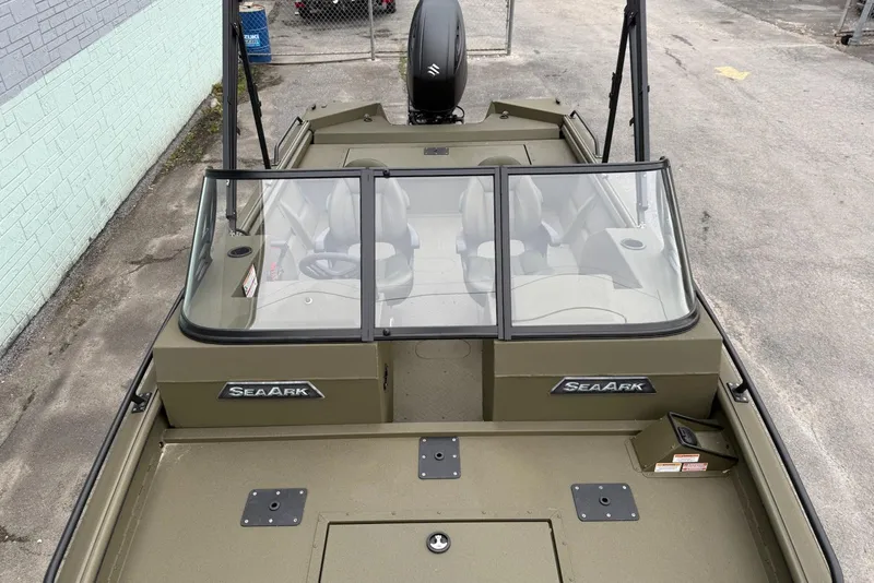 Slide: The Image of 2026 SeaArk Protege 200 boat with windshield and seating, parked outdoors. - 10