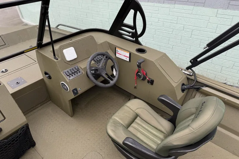 Slide: The Image of 2026 SeaArk Protege 200 boat interior with steering wheel and comfortable seating. - 7