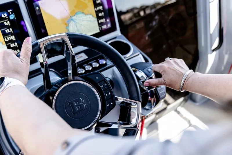 Slide: The Image of Steering wheel of 2024 BRABUS SHADOW 300 CT with navigation display in background. - 9