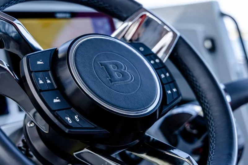 Slide: The Image of Steering wheel of 2024 BRABUS SHADOW 300 CT with control buttons. - 12