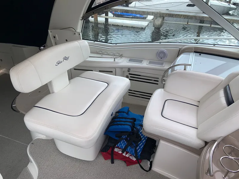 Slide: The Image of Interior of 2005 Sea Ray 500 Sundancer yacht with white seating and life jackets. - 11