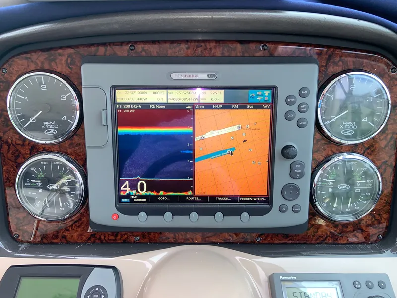 Slide: The Image of Dashboard of a 2005 Sea Ray 500 Sundancer with navigation and engine gauges. - 23