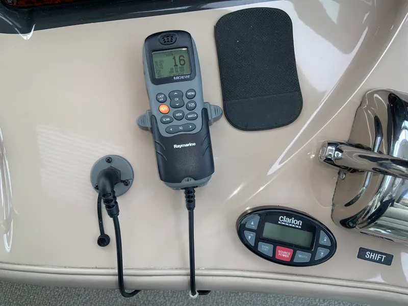 Slide: The Image of Control panel of a 2005 Sea Ray 500 Sundancer with Raymarine radio and Clarion audio system. - 25