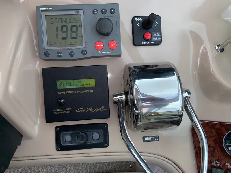 Slide: The Image of Control panel of a 2005 Sea Ray 500 Sundancer boat with navigation and throttle controls. - 26
