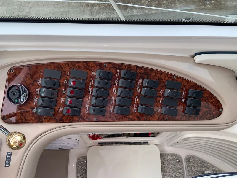 Slide: The Image of Control panel of a 2005 Sea Ray 500 Sundancer boat with switches and labels. - 27