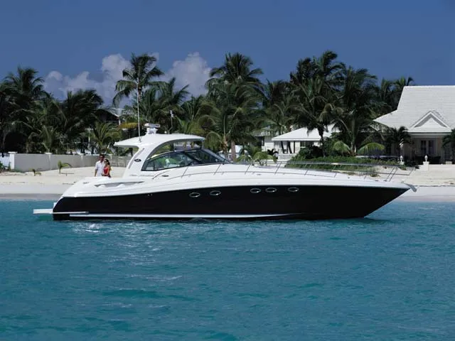 Slide: The Image of 2005 Sea Ray 500 Sundancer yacht cruising near a tropical beach with palm trees. - 3