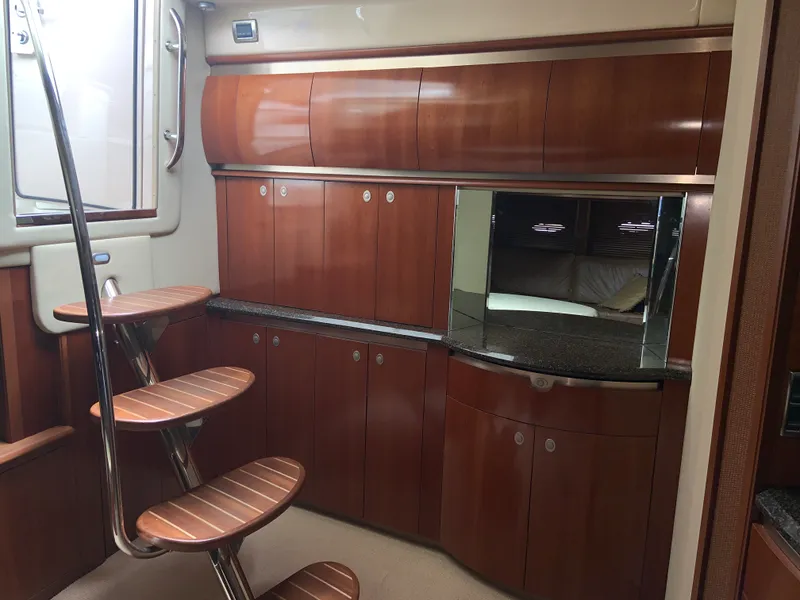 Slide: The Image of Interior of 2005 Sea Ray 500 Sundancer yacht with wooden cabinetry and spiral staircase. - 30