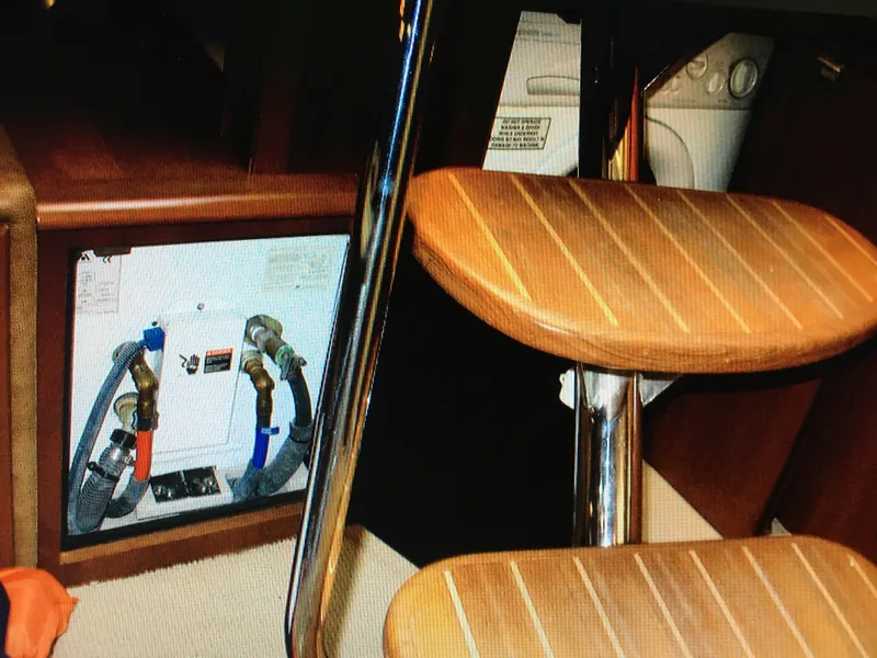 Slide: The Image of 2005 Sea Ray 500 Sundancer interior with wooden steps and utility connections. - 31