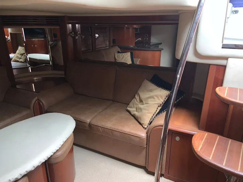 Slide: The Image of Luxurious interior of 2005 Sea Ray 500 Sundancer yacht with leather seating and wooden accents. - 33