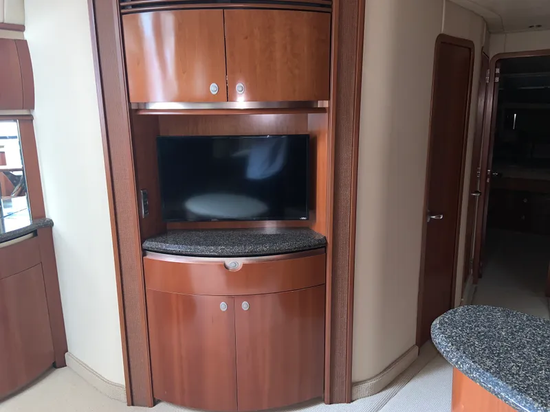 Slide: The Image of Interior of 2005 Sea Ray 500 Sundancer with wood cabinetry and mounted TV. - 40