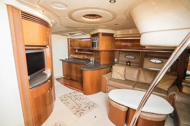Slide: The Image of Luxurious interior of 2005 Sea Ray 500 Sundancer yacht with modern kitchen and seating area. - 43