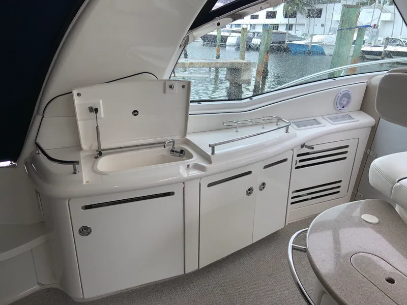 Slide: The Image of 2005 Sea Ray 500 Sundancer yacht interior with kitchenette and seating area. - 7