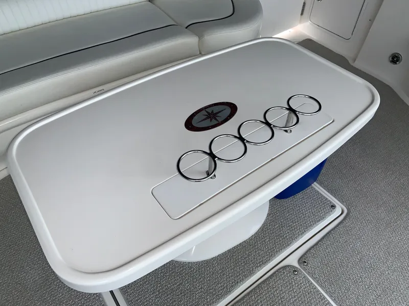 Slide: The Image of 2005 Sea Ray 500 Sundancer boat interior with table and cup holders. - 8