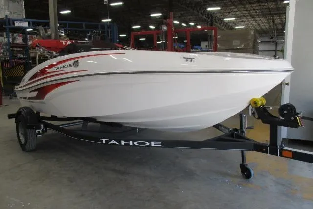 The Image of 2024 Tahoe T16 boat on trailer in warehouse setting. - 1