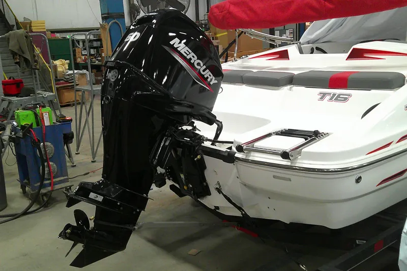 Slide: The Image of 2024 Tahoe T16 boat with Mercury outboard motor in a workshop setting. - 13