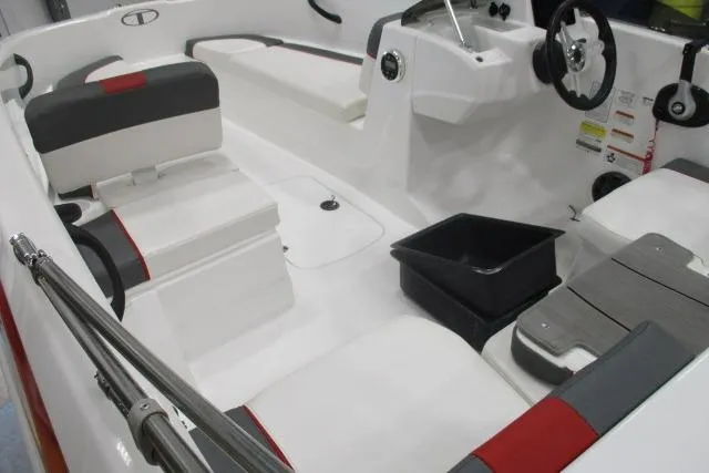 Slide: The Image of 2024 Tahoe T16 boat interior with white and red seating, steering wheel, and storage compartments. - 3