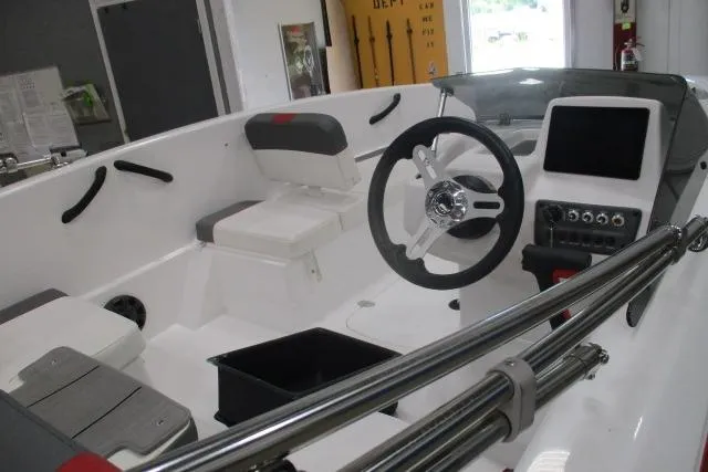 Slide: The Image of 2024 Tahoe T16 boat interior with steering wheel and seating, showcasing modern design. - 4