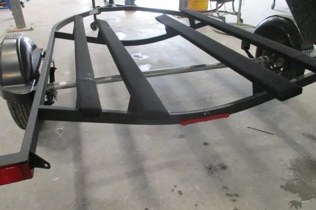 Slide: The Image of 2024 Tahoe T16 boat trailer with black frame and fenders in a workshop setting. - 9