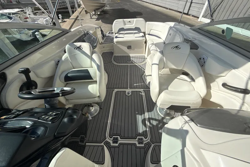 Slide: The Image of 2013 Monterey 264FS boat interior with white seating and sleek dashboard design. - 11