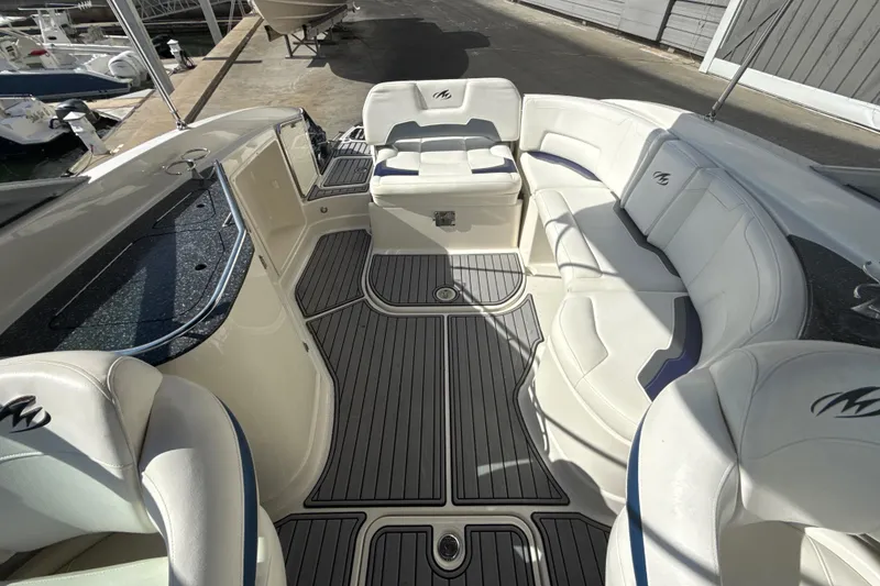Slide: The Image of 2013 Monterey 264FS boat interior with white seating and sleek flooring. - 12