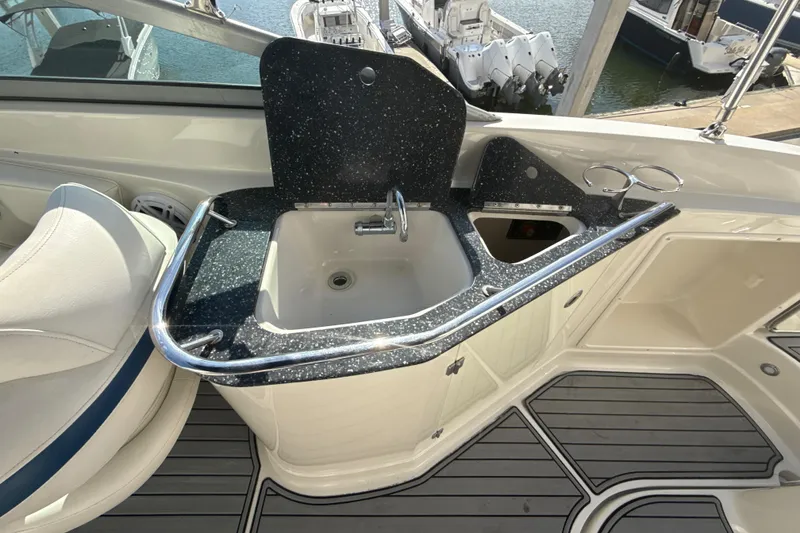 Slide: The Image of 2013 Monterey 264FS boat interior with sink and countertop, docked at marina. - 15
