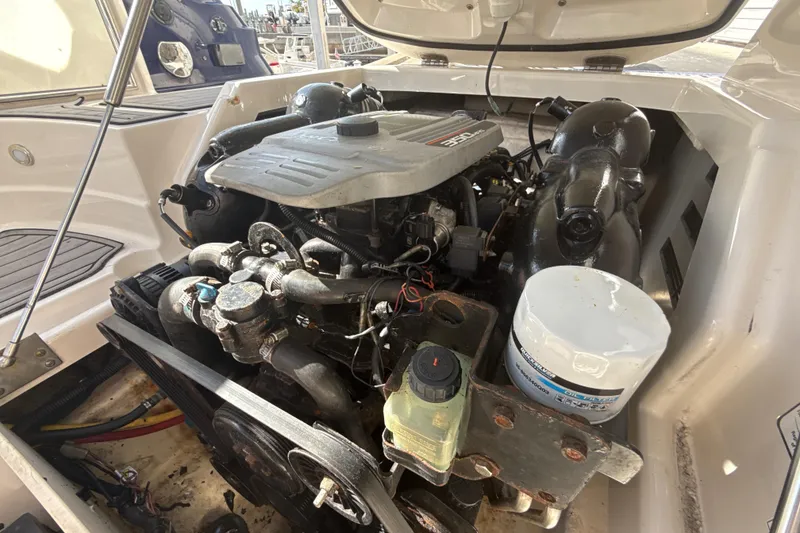 Slide: The Image of Engine compartment of a 2013 Monterey 264FS boat, showcasing detailed mechanical components. - 16