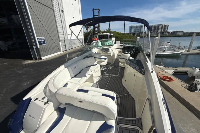 Slide: The Image of 2013 Monterey 264FS boat docked, featuring spacious seating and sleek design. - 20