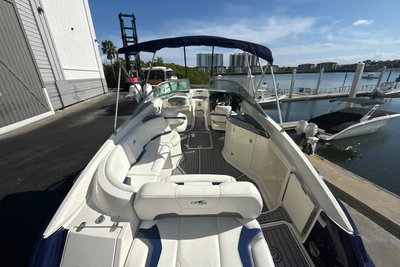 Slide: The Image of 2013 Monterey 264FS boat docked, featuring spacious seating and sleek design. - 5