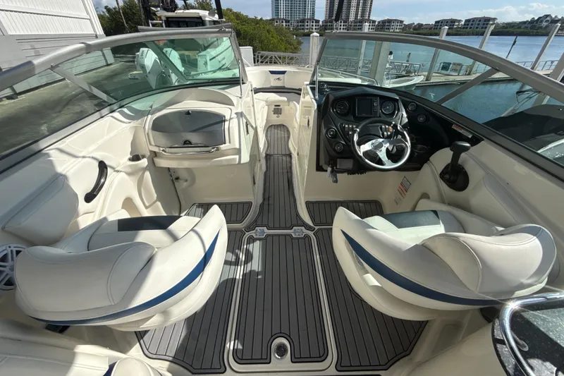 Slide: The Image of Interior view of a 2013 Monterey 264FS boat with white seating and modern dashboard. - 6