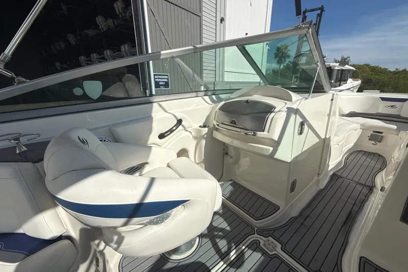 Slide: The Image of 2013 Monterey 264FS boat interior with white seating and sleek dashboard design. - 8