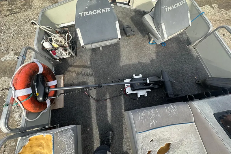 Slide: The Image of 1992 Sun Tracker Bass Buggy 18 Classic Series interior with seats, trolling motor, and life preserver. - 10