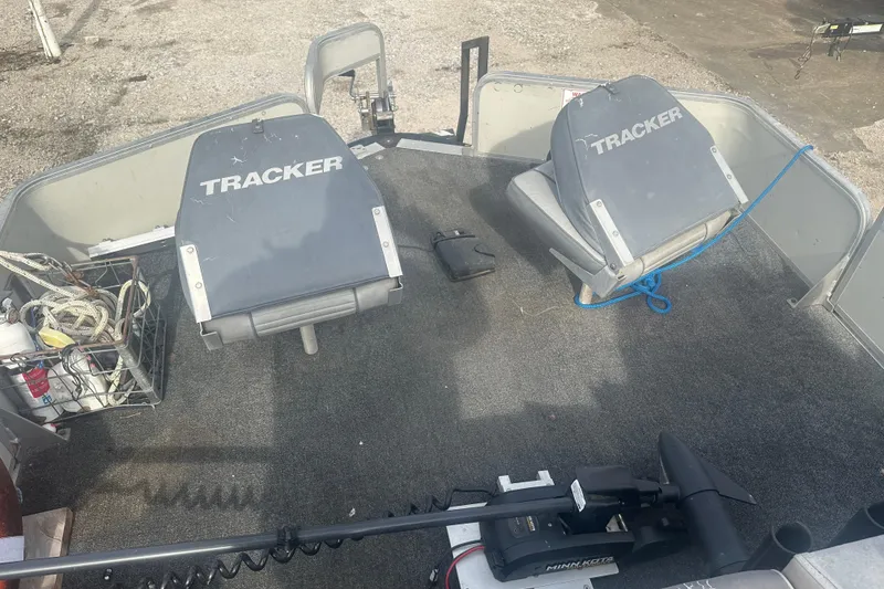 Slide: The Image of 1992 Sun Tracker Bass Buggy 18 Classic Series boat interior with Tracker seats and fishing gear. - 11