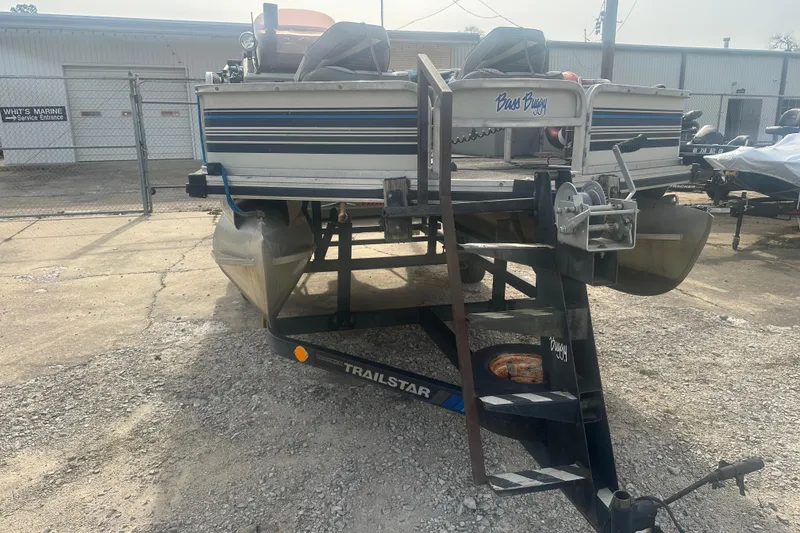Slide: The Image of 1992 Sun Tracker Bass Buggy 18 Classic pontoon boat on a trailer in a parking lot. - 4