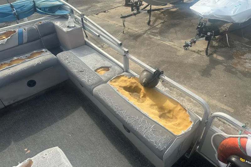 Slide: The Image of 1992 Sun Tracker Bass Buggy 18 Classic Series with worn, damaged seating and exposed foam. - 6