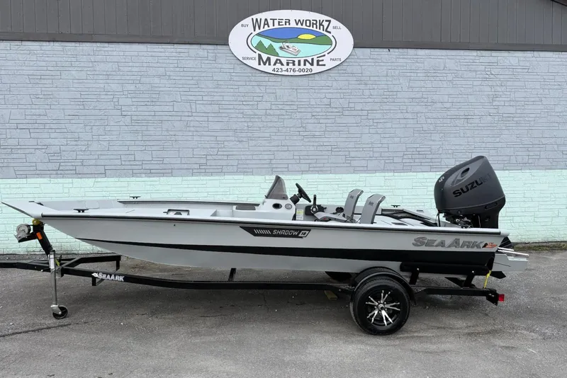The Image of 2026 SeaArk Shadow 187 boat with Suzuki engine on trailer, parked outside Water Workz Marine. - 1