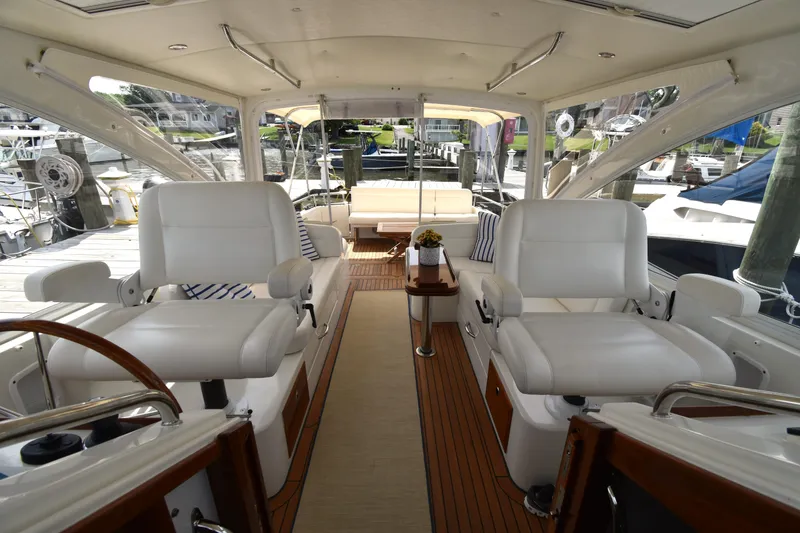 Slide: The Image of Interior of 2011 MJM 40z Downeast yacht with white seating and wooden flooring. - 12