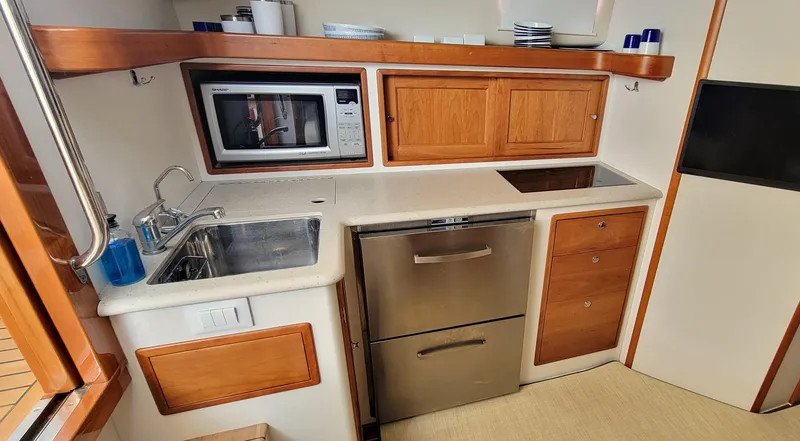 Slide: The Image of Compact kitchen in 2011 MJM 40z Downeast boat with sink, microwave, and storage. - 21