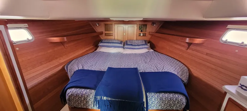Slide: The Image of 2011 MJM 40z Downeast boat cabin with cozy bed and wooden interior. - 23