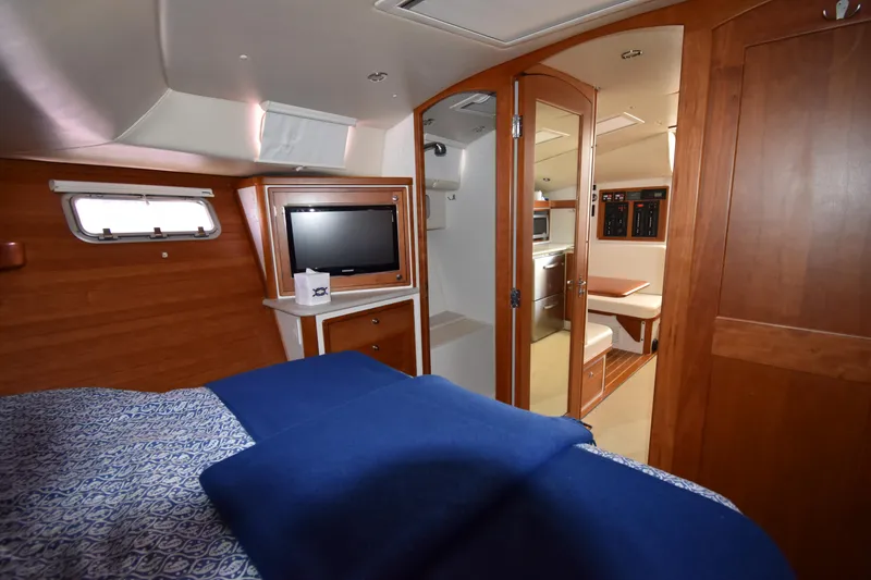 Slide: The Image of 2011 MJM 40z Downeast yacht interior with cozy cabin, TV, and dining area. - 24