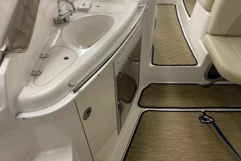 Slide: The Image of 2005 Chaparral Signature 310 boat interior with sink and seating area. - 10
