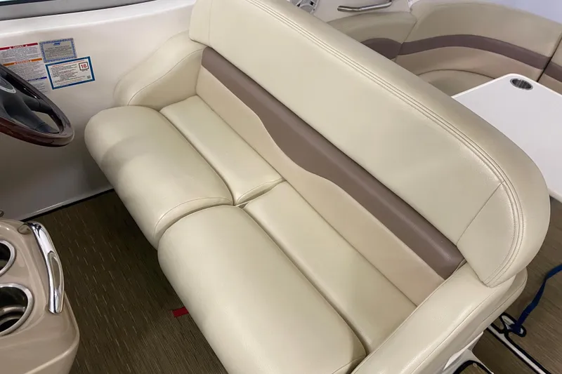 Slide: The Image of 2005 Chaparral Signature 310 boat interior with beige leather seating and wooden steering wheel. - 5