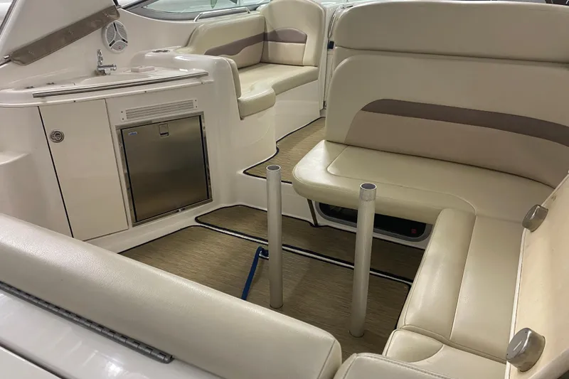 Slide: The Image of 2005 Chaparral Signature 310 boat interior with beige seating and kitchenette. - 6
